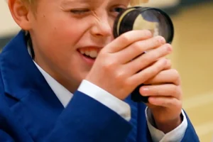 boy with magnifying glass looking for csi evidence boy with magnifying glass looking for csi evidence